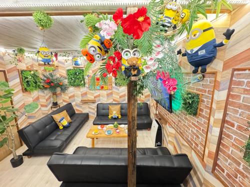 a living room with couches and a tree with flowers at New open Hotel Jungle fun fun J5 USJ10 minutes in Osaka