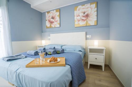 a bedroom with a bed with a tray of food on it at Casa Marlene Luxury SeaFront in Güimar