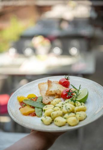 a plate of food with meat and vegetables on it at Hotel am Haslinger Hof in Bad Füssing