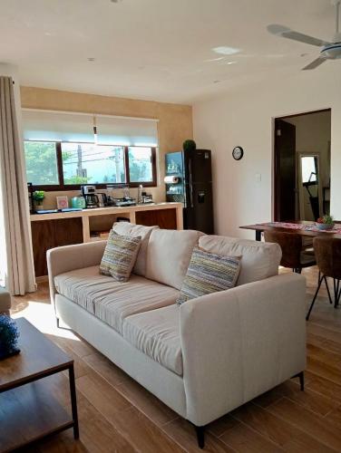 a living room with a white couch and a table at Mar y Chelo Luxury Aparments in Isla Mujeres