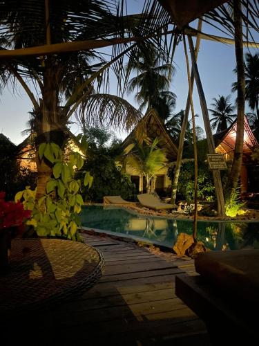 a resort with a swimming pool and a house at The Nest Tropical Oasis Resort in Paje