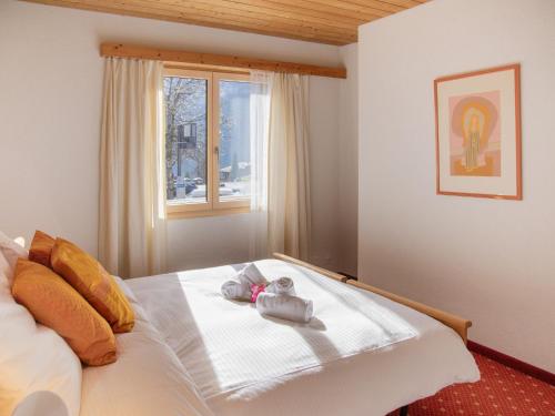 a bedroom with a bed with towels on it at Apartment Chalet Abendrot apARTments-15 by Interhome in Grindelwald
