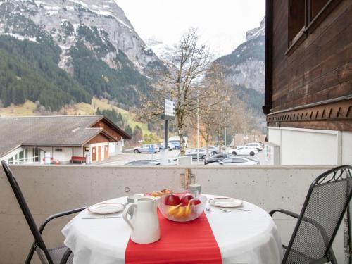 a table with a bowl of fruit on a balcony at Apartment Chalet Abendrot apARTments-12 by Interhome in Grindelwald