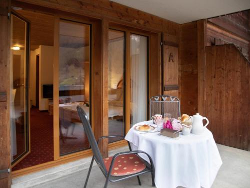 a table in a room with a table and chairs at Apartment Chalet Abendrot apARTments-7 by Interhome in Grindelwald