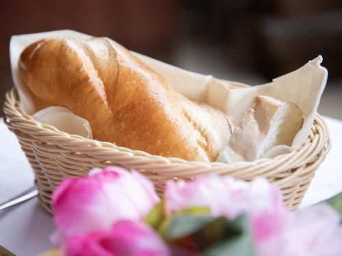 a basket with a loaf of bread next to flowers at Apartment Chalet Abendrot apARTments-7 by Interhome in Grindelwald