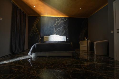 a bedroom with a bed on a marble floor at Suite Relax 1 in Coazzano