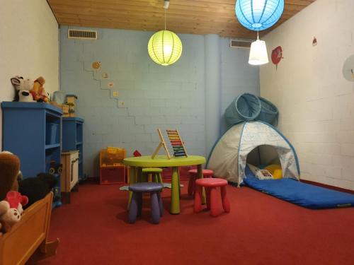 a room with a tent and a table and stools at Apartment Chalet Abendrot apARTments-26 by Interhome in Grindelwald