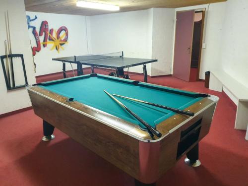a pool table in a room with two ping pong tables at Apartment Chalet Abendrot apARTments-9 by Interhome in Grindelwald