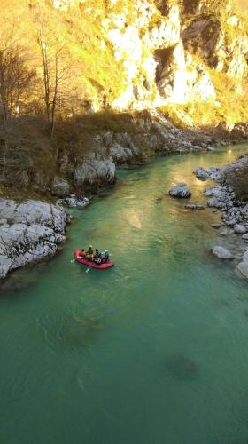a group of people in a boat on a river at Studio Brnat in Kobarid