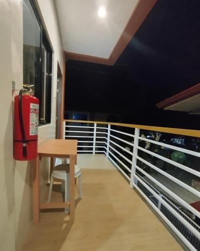 a balcony with a table and a fire extinguisher at JAG Homes in Puerto Princesa City