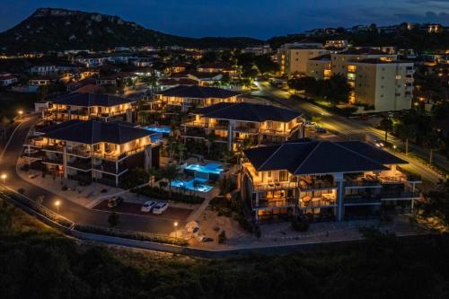 an aerial view of a city at night at The Breeze Escape in Blue Bay