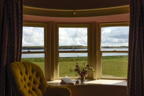 a room with a window with a chair and a table at Mount Vernon, Flaggy Shore, County Clare in Burren