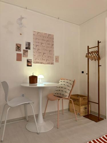 a table and a chair in a room at Sillim Leo's House in Seoul