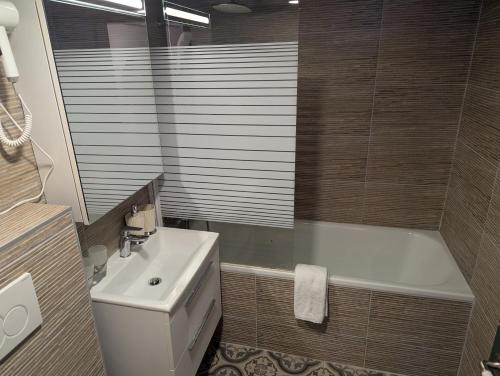 a bathroom with a toilet and a sink and a tub at Hotel Schützen Lauterbrunnen in Lauterbrunnen