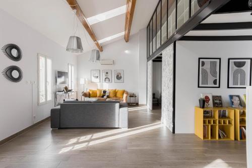 - un salon avec un canapé gris et des fauteuils jaunes dans l'établissement Loft Meynadier by Halldis, à Cannes