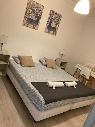 a bedroom with a bed with two towels on it at Oriente DNA Studios II in Lisbon