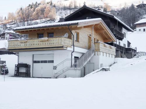 a house with a balcony on top of a snow covered slope at Chalet Wildenbach by Interhome in Grafenweg