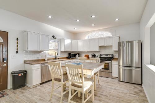 a kitchen with white cabinets and a table and chairs at Big Stone Lake Access Home with Private Beach in Ortonville