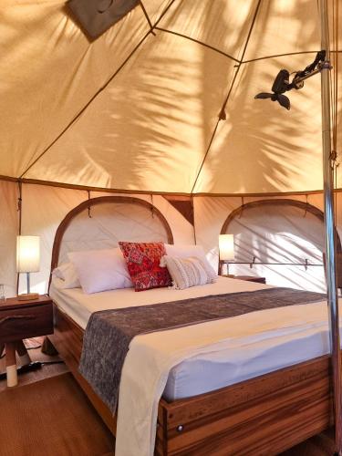 a bedroom with a bed in a tent at The Jaguars Jungle Rainforest Lodge - All meals included in San Pedrillo