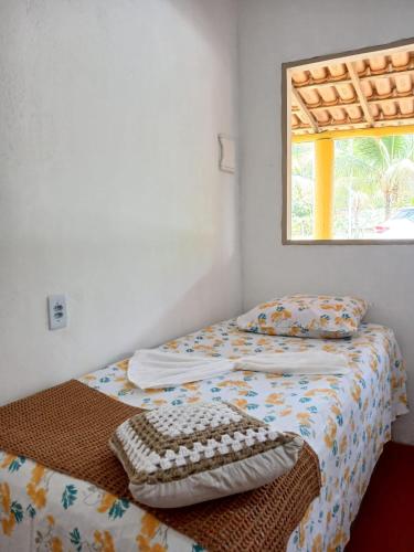 Ένα ή περισσότερα κρεβάτια σε δωμάτιο στο Chalé Ilha Verde-Cumuruxatiba