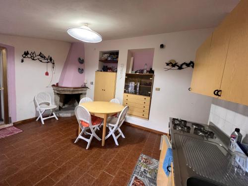 a kitchen with a table and chairs in a room at Villa Cristina in Santa Caterina