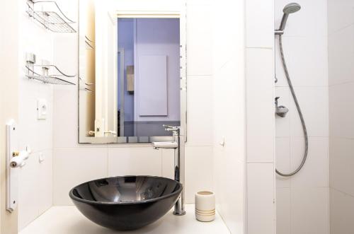 La salle de bains est pourvue d'une douche avec lavabo à bol noir. dans l'établissement VIO-LETTES - Agréable deux pièces - Proche Mer, à Roquebrune-Cap-Martin