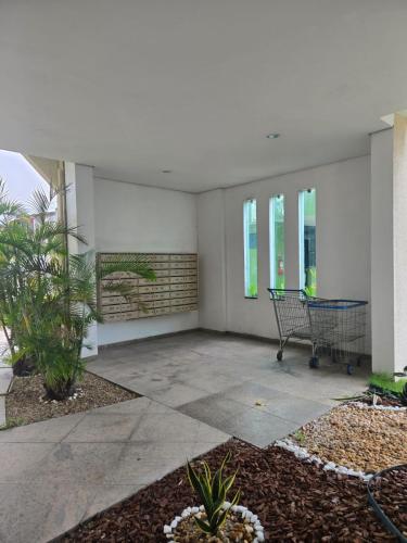 an empty patio with chairs and plants in a building at Apartamento Manaus Arena da Amazonia in Manaus