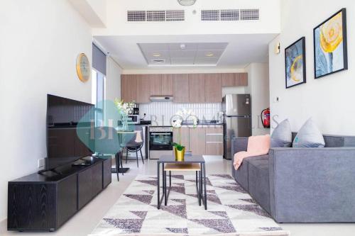 a living room with a couch and a table at Bloomfields Magnificent Stu In View Raha Beach in Abu Dhabi