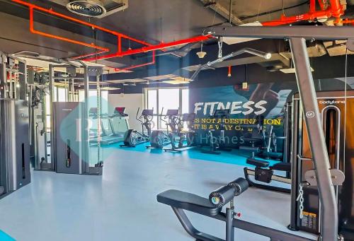 a gym with cardio equipment in a fitness center at Bloomfields Hidden Gem 1br In Elyacout Tower in Abu Dhabi