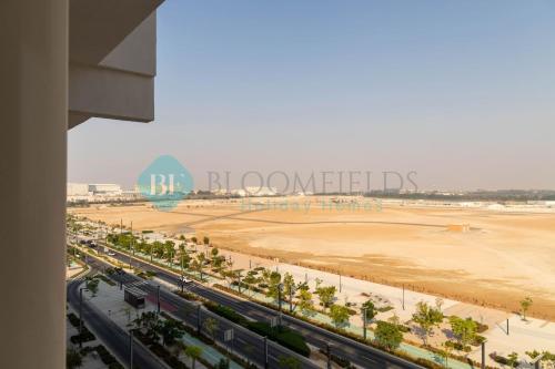 an aerial view of a beach and a city at Bloomfields Mesmerizing 1br In Oasis Masdar City in Al Qurayyah