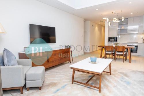 a living room with a couch and a table at Bloomfields Iconic 2br & Maid Address Beach Resort in Fujairah