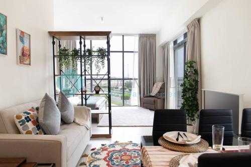 a living room with a couch and a table at Bloomfields Artistic Stu In The View Raha Beach in Abu Dhabi