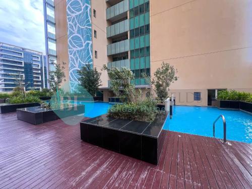 a swimming pool in the middle of a building at Bloomfields Adorable 1br In Raha Beach Access in Abu Dhabi