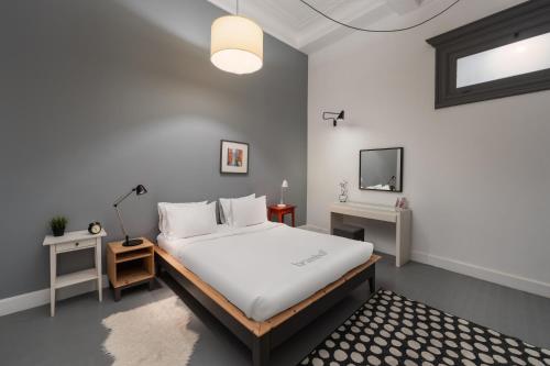 a bedroom with a large bed and a tv at grey l studio apartments Corniche Alexandria Little Venice in Alexandria
