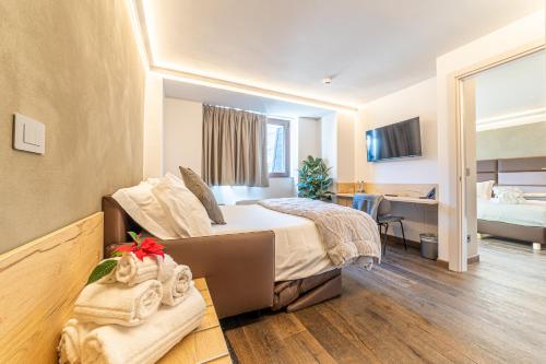 a hotel room with a bed and a desk at Riserva Bianca Limone Hotel & SPA in Limone Piemonte