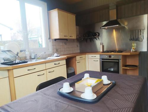 a kitchen with a table with a tray of food on it at Petit Nid Urbain Proche RER, 25min Paris Centre Chambre privée et SDB privée indépendante in Stains