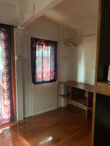 a room with two windows and a wooden floor at Pimmada Hut in Haad Pleayleam