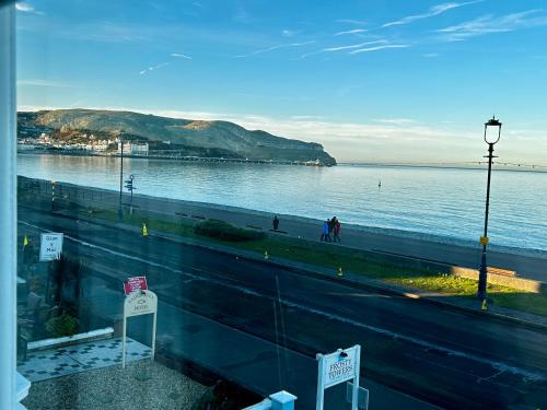 a view of a body of water from a window at Hotel No5, Beachfront with Free Private Car Park in Llandudno