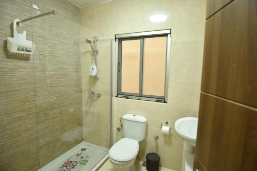 a bathroom with a toilet and a sink at Sea Breeze Nest in St Paul's Bay