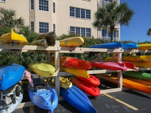 a group of kayaks on shelves in a parking lot at Catch of the Day at Harbor Towers on Siesta Key in Siesta Key