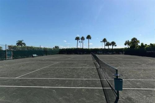 a tennis court with a net in the middle at Catch of the Day at Harbor Towers on Siesta Key in Siesta Key