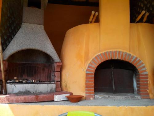 an outdoor pizza oven with a brick ovenasteryasteryasteryasteryasteryasteryasteryastery at beautiful cottage with pool: 8 pers in Isolabona