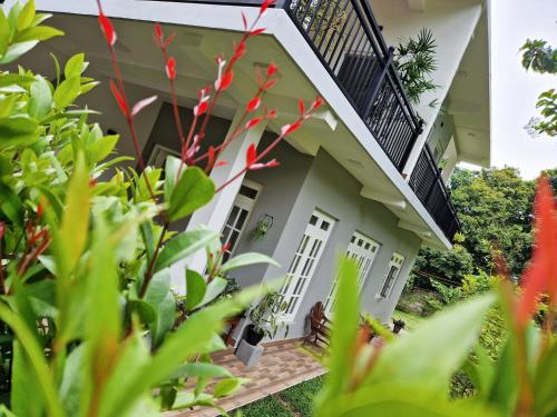 a house with red flowers in front of it at Villa Sole in Kandy