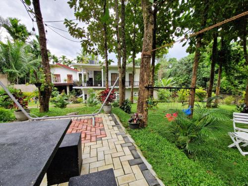 a backyard with a ping pong table and trees at Villa Sole in Kandy