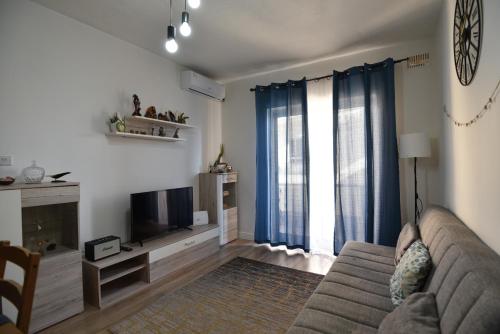 a living room with a couch and a television at Sea Breeze Nest in St Paul's Bay