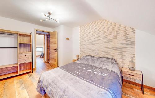 a bedroom with a bed and a wooden wall at Pet Friendly Home In Charnois With Wifi in Charnois