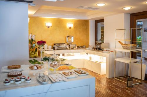 a kitchen with a counter with food on it at Hotel Capri in Malcesine