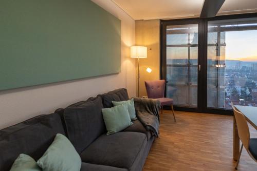a living room with a couch and a large window at Apartment "Green Bamboo" - Business-30 qm-ruhig-Parkplatz-Arbeitsplatz in Leonberg