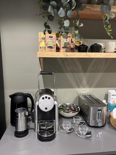 a kitchen counter with a coffee maker and a toaster at Arrábida Guest House in Setúbal