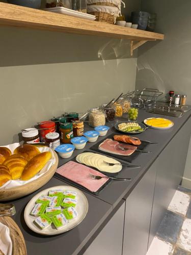 a kitchen counter with plates of food on it at Arrábida Guest House in Setúbal